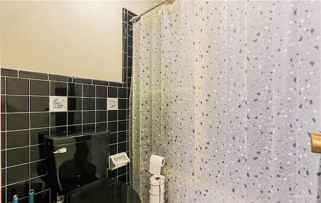 bathroom featuring tile walls and a shower with shower curtain