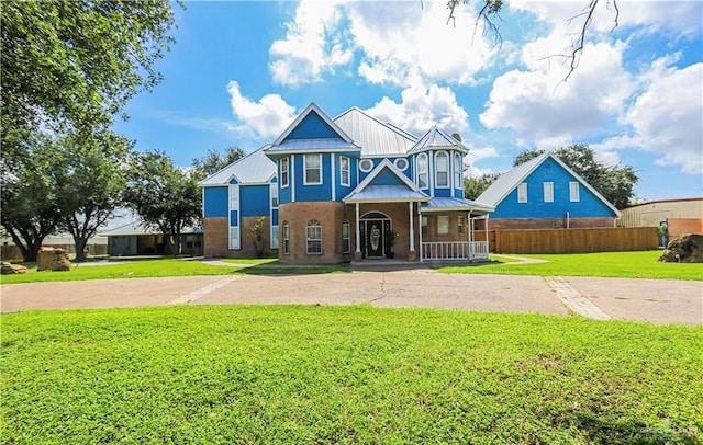 view of front facade with a front lawn and a porch