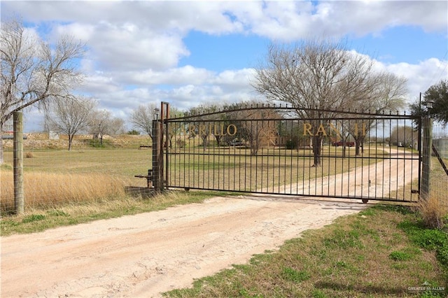 view of gate featuring a lawn