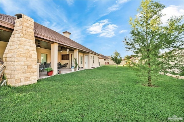 view of yard with a patio area and ceiling fan