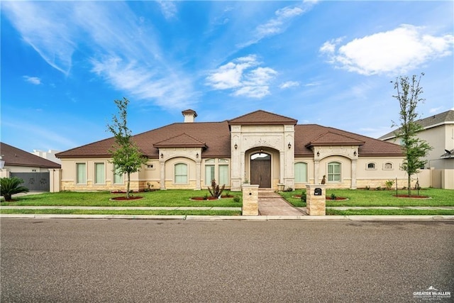 mediterranean / spanish-style home featuring a front lawn