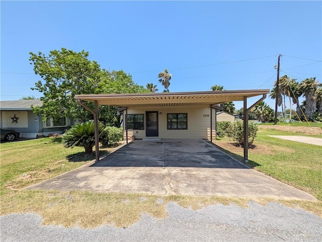 106 Resaca Shores Dr S, Los Fresnos, TX 78566 - view of front of home with a front yard, asphalt driveway, and an attached carport