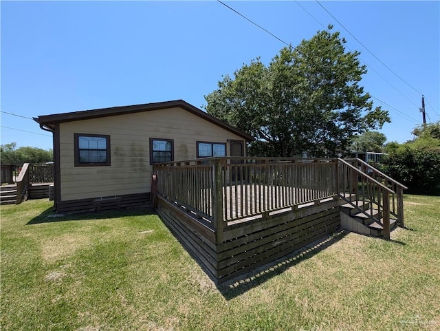 106 Resaca Shores Dr S, Los Fresnos, TX 78566 - back of property featuring a wooden deck, stairs, and a yard