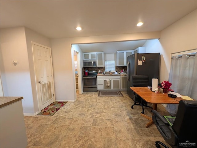 106 Resaca Shores Dr S, Los Fresnos, TX 78566 - kitchen featuring appliances with stainless steel finishes, tasteful backsplash, glass insert cabinets, baseboards, and a sink