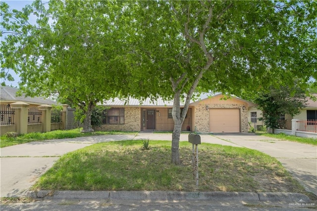 1207 Dolores Del Rio Ave, Mission, TX 78572 - view of front of house featuring driveway, a garage, and brick siding