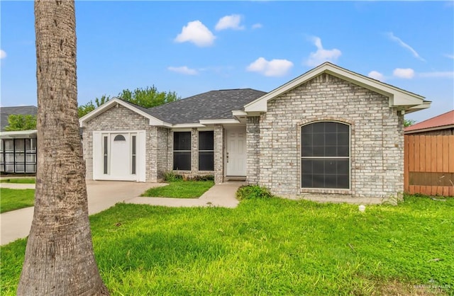 ranch-style home with a front lawn