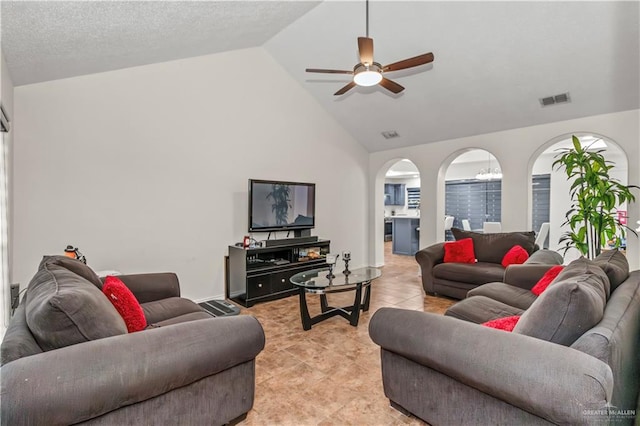 living room with ceiling fan, light tile patterned floors, a textured ceiling, and high vaulted ceiling