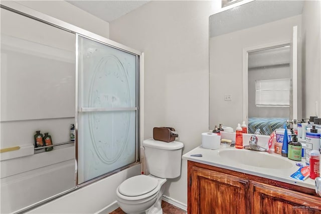 full bathroom featuring toilet, vanity, and combined bath / shower with glass door