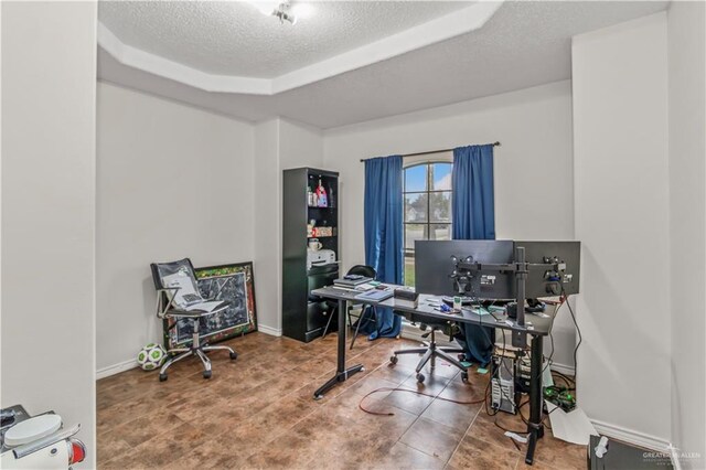 home office featuring a textured ceiling and a raised ceiling