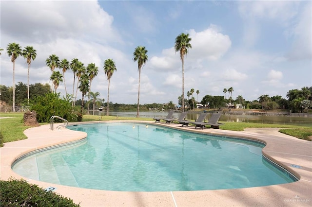 view of swimming pool with a water view and a patio area