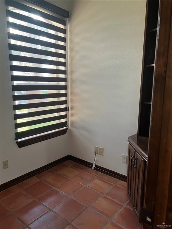 unfurnished room with tile patterned floors