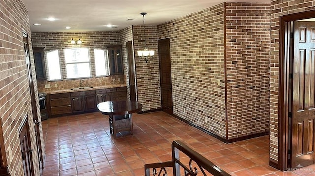 bathroom with vanity and brick wall