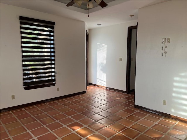 tiled empty room with ceiling fan