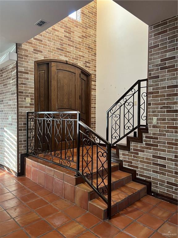 staircase with brick wall