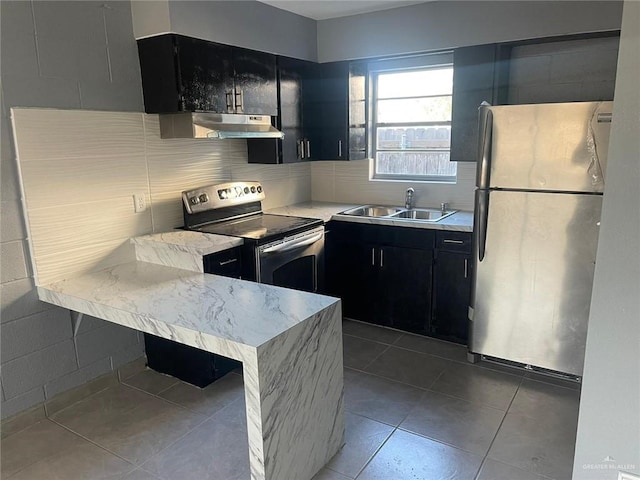 kitchen with light tile patterned floors, stainless steel appliances, tasteful backsplash, and sink