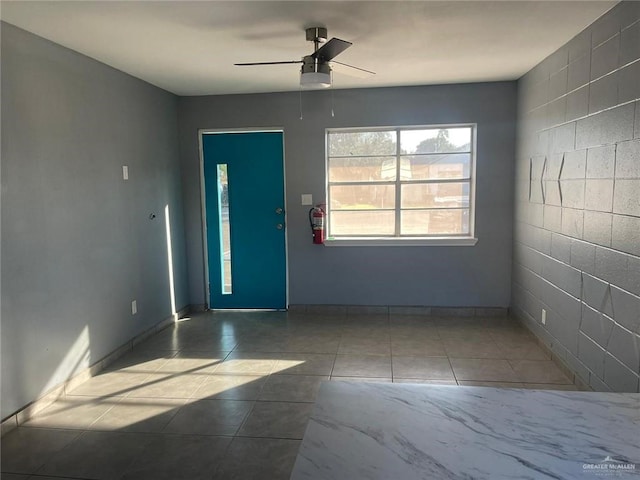 tiled foyer entrance with ceiling fan