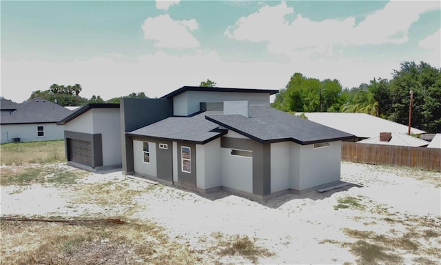 3724 E Diamondhead Ave, Alton, TX 78573 - contemporary home with stucco siding, a garage, and a shingled roof