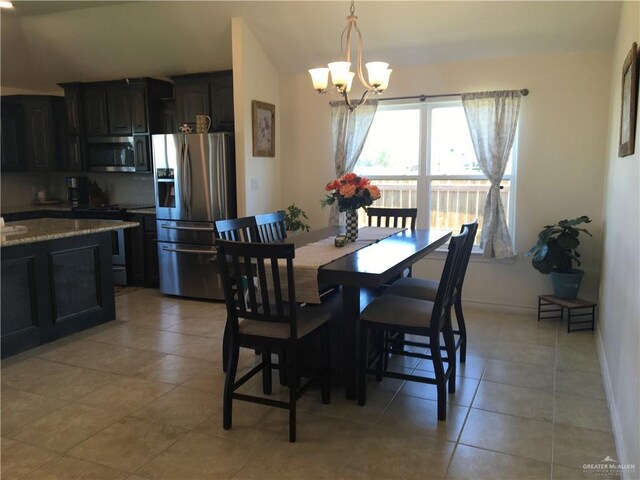 7507 55th Ln, Mcallen, TX 78504 - dining room featuring an inviting chandelier, baseboards, and light tile patterned floors