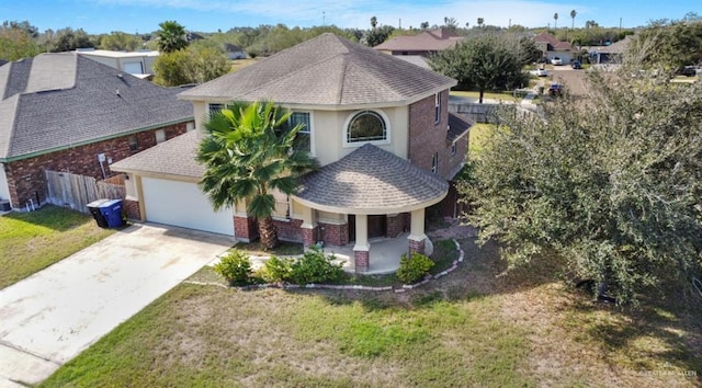 view of front of home featuring a front lawn, covered porch, and a garage