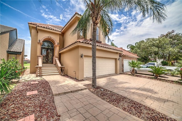 mediterranean / spanish-style house with french doors and a garage