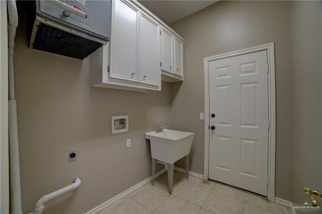 clothes washing area featuring cabinets, light tile patterned floors, electric dryer hookup, and washer hookup