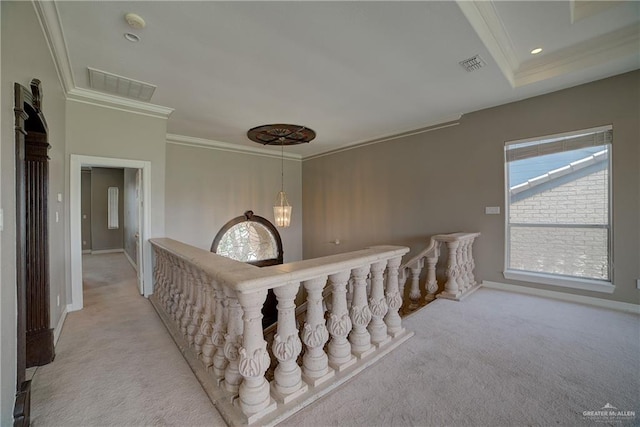 corridor featuring light carpet, crown molding, and a notable chandelier