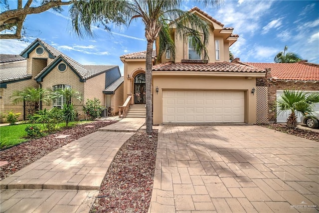 mediterranean / spanish-style house with a garage