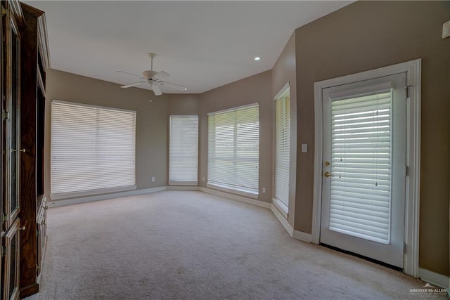 interior space with ceiling fan