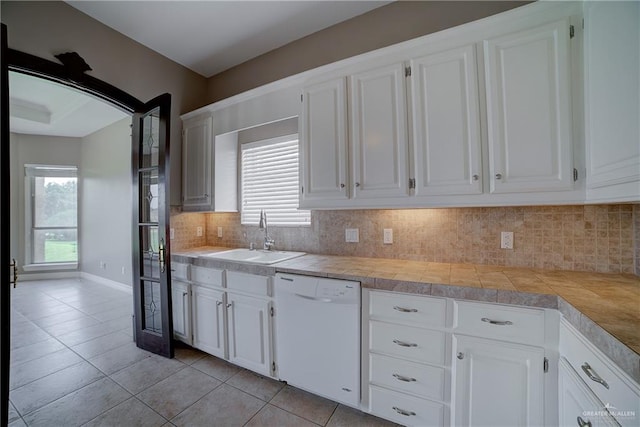 kitchen featuring white cabinetry, dishwasher, and sink