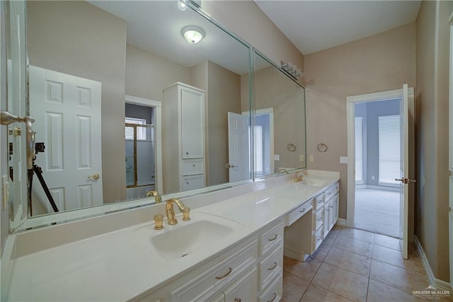 bathroom featuring tile patterned floors, vanity, and a healthy amount of sunlight