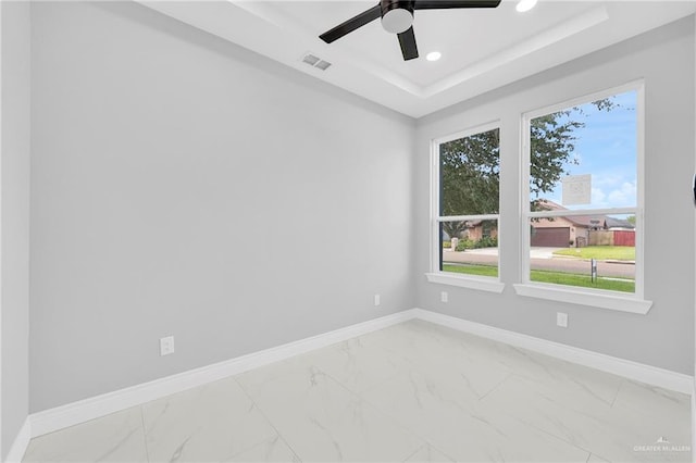 1915 Chandler Cir, Edinburg, TX 78542 - unfurnished room featuring marble look tiles, a raised ceiling, recessed lighting, and ceiling fan