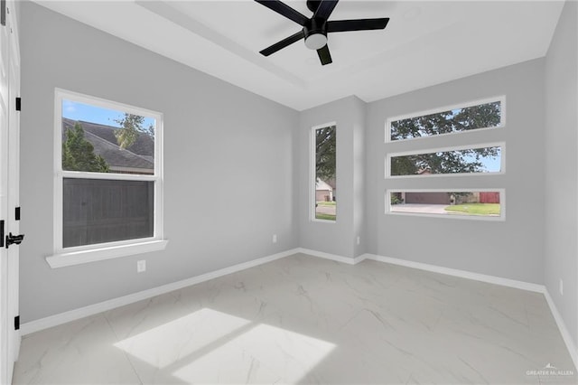 1915 Chandler Cir, Edinburg, TX 78542 - unfurnished room featuring marble look tiles, ceiling fan, and a raised ceiling