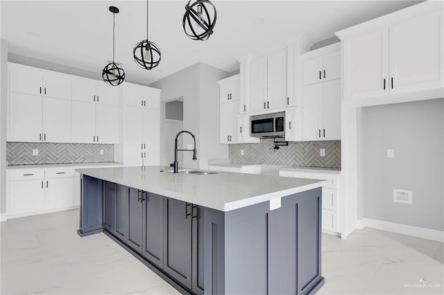 1915 Chandler Cir, Edinburg, TX 78542 - kitchen featuring light marble finish floors, decorative backsplash, and white cabinetry