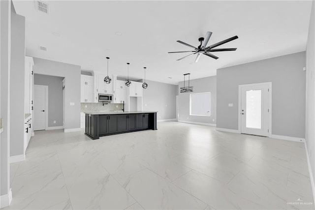 1915 Chandler Cir, Edinburg, TX 78542 - unfurnished living room featuring a ceiling fan and light marble finish floors