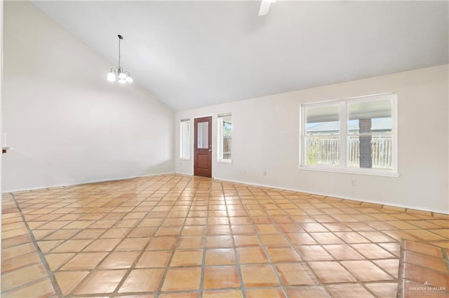 unfurnished room featuring high vaulted ceiling and a notable chandelier