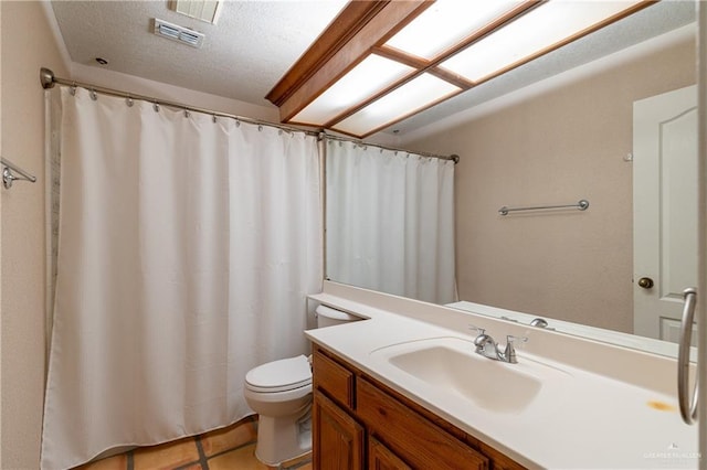 bathroom featuring tile patterned flooring, vanity, and toilet