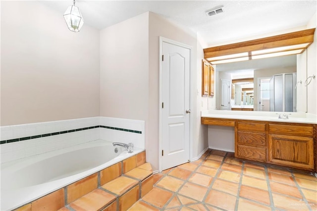 full bathroom with a garden tub, visible vents, and vanity