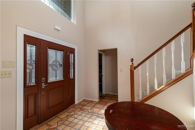 foyer entrance with a towering ceiling and a wealth of natural light