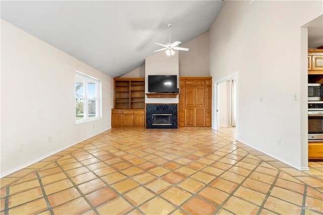 unfurnished living room featuring a ceiling fan, a fireplace, and high vaulted ceiling