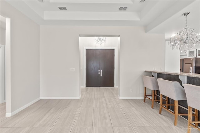 4630 Kristine Dr, Harlingen, TX 78552 - interior space with a tray ceiling, an inviting chandelier, and visible vents