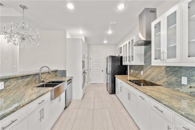 4630 Kristine Dr, Harlingen, TX 78552 - kitchen featuring wall chimney exhaust hood, light stone countertops, tasteful backsplash, a sink, and stainless steel appliances