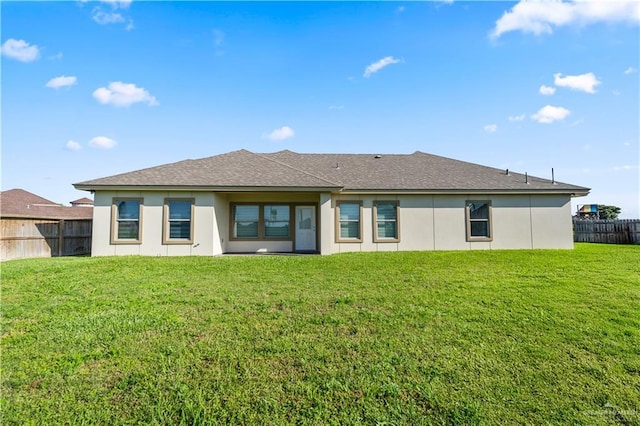 4630 Kristine Dr, Harlingen, TX 78552 - back of house with a yard, a shingled roof, and fence