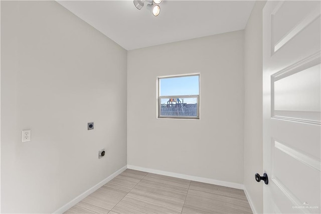 4630 Kristine Dr, Harlingen, TX 78552 - laundry room with baseboards, light tile patterned floors, electric dryer hookup, and laundry area