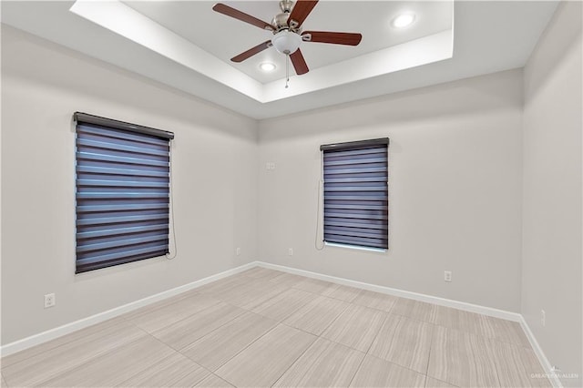 4630 Kristine Dr, Harlingen, TX 78552 - spare room with a raised ceiling, baseboards, a ceiling fan, and recessed lighting