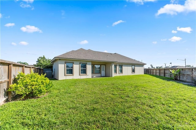 4630 Kristine Dr, Harlingen, TX 78552 - rear view of property featuring a shingled roof, a yard, a fenced backyard, and stucco siding