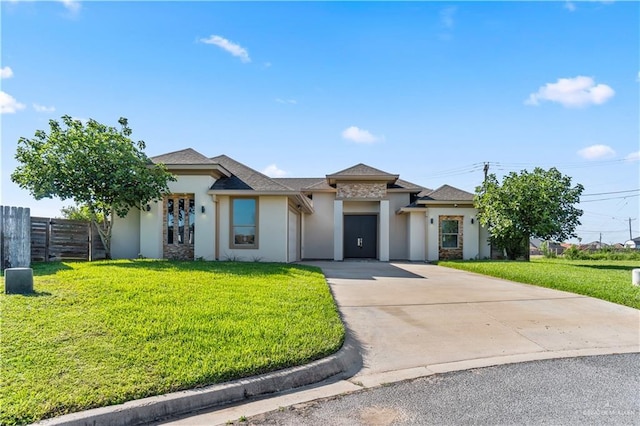 4630 Kristine Dr, Harlingen, TX 78552 - prairie-style house featuring driveway, stucco siding, fence, and a front yard