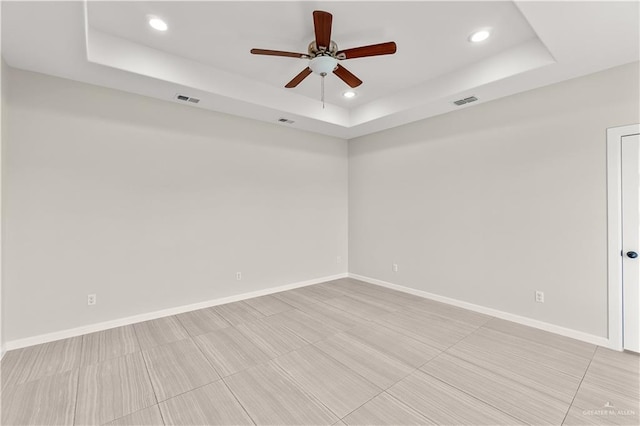 4630 Kristine Dr, Harlingen, TX 78552 - spare room with visible vents, baseboards, a raised ceiling, ceiling fan, and recessed lighting
