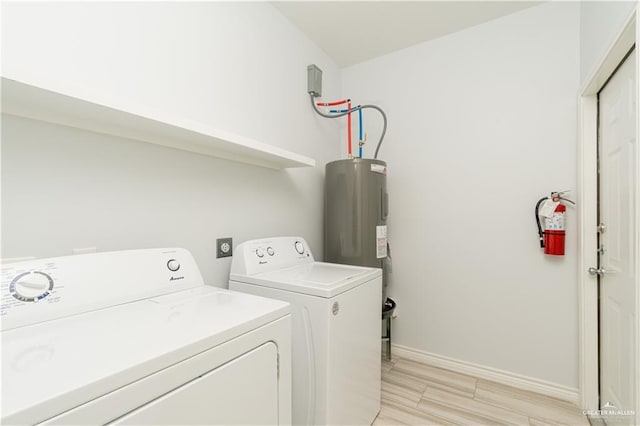 laundry room with water heater and washing machine and clothes dryer