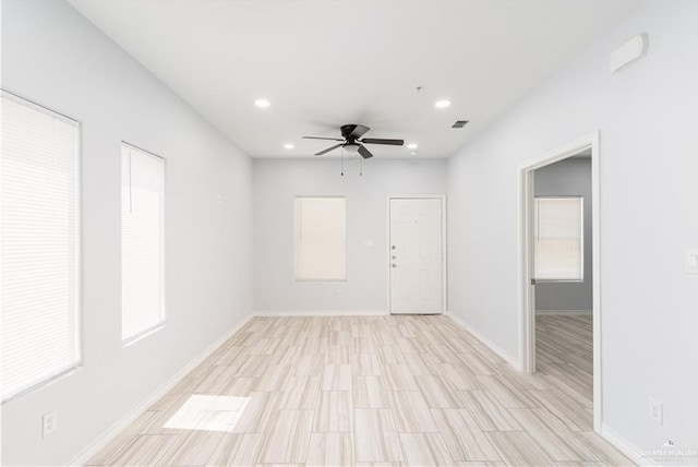 unfurnished room featuring ceiling fan and light hardwood / wood-style floors