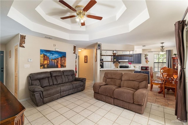 605 W Lozano St, Harlingen, TX 78550 - living room featuring a tray ceiling, ceiling fan, and light tile patterned floors